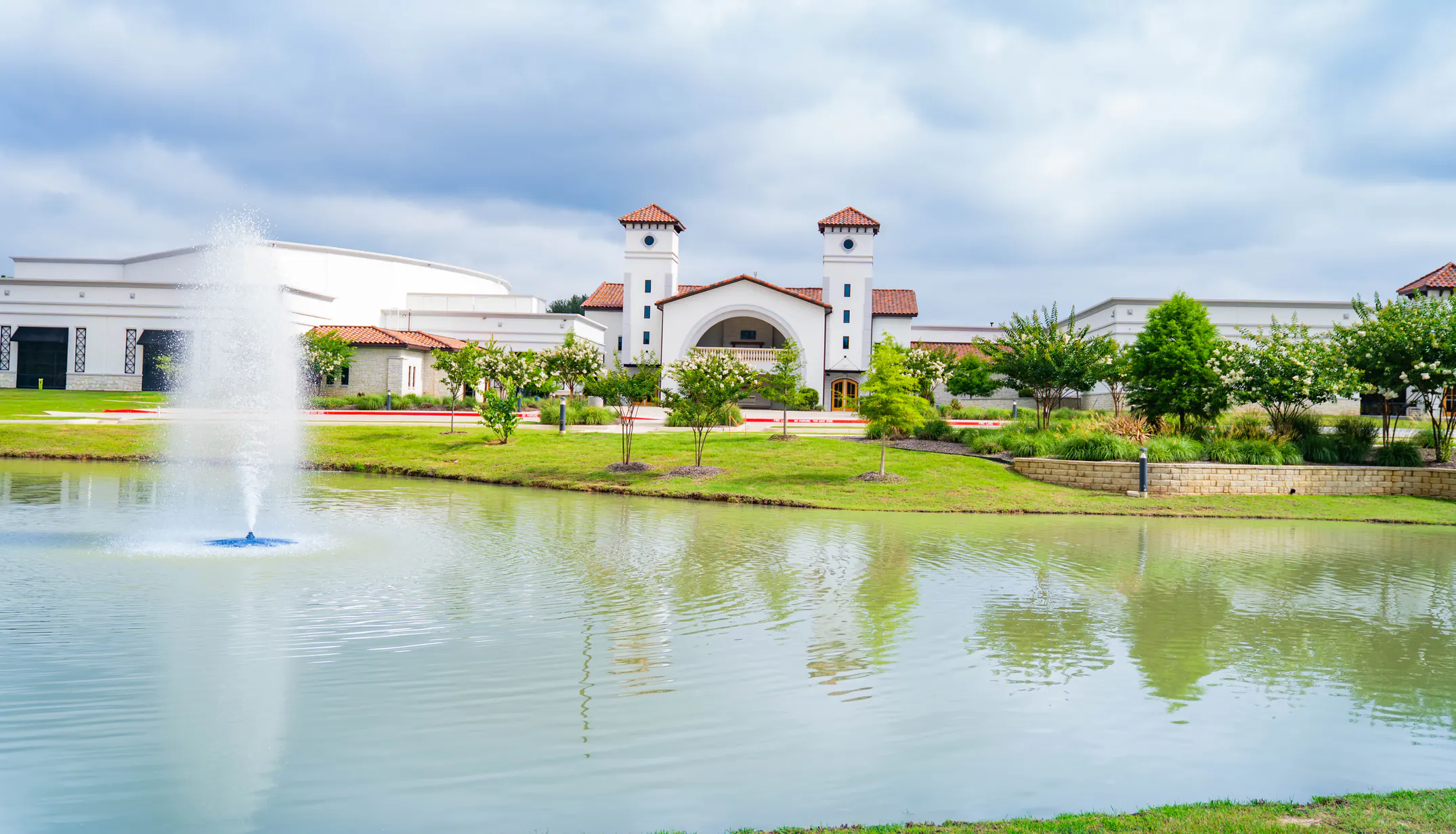 The Keystone Church campus seen across the pond, with the fountain in the foreground